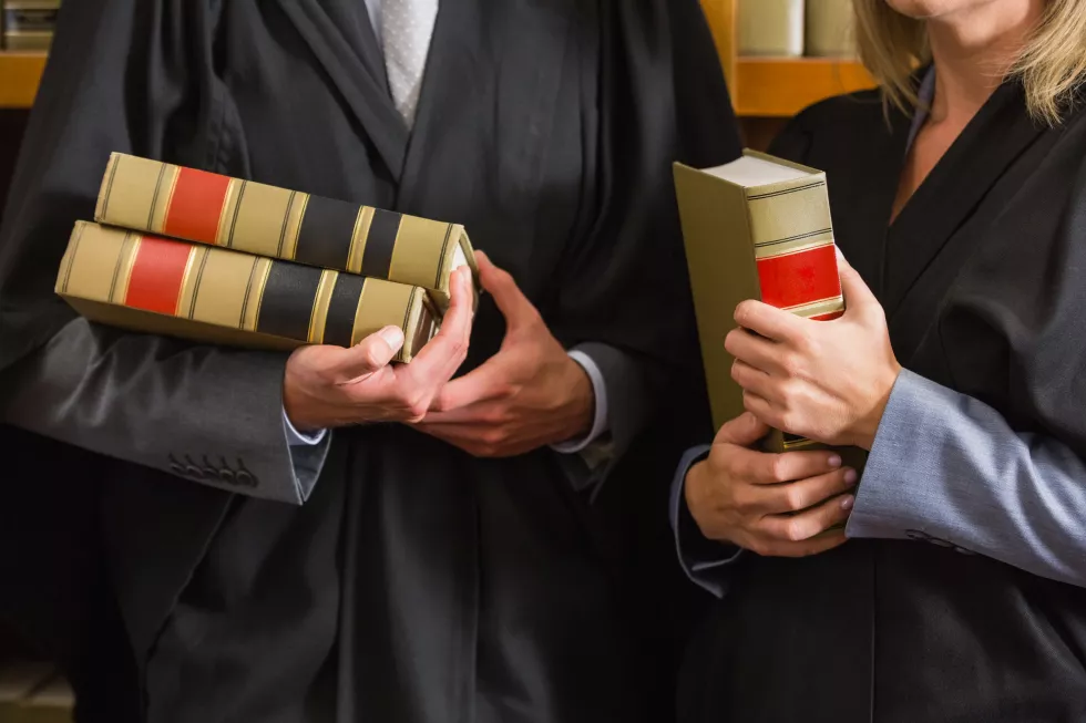 lawyers-holding-books-law-library