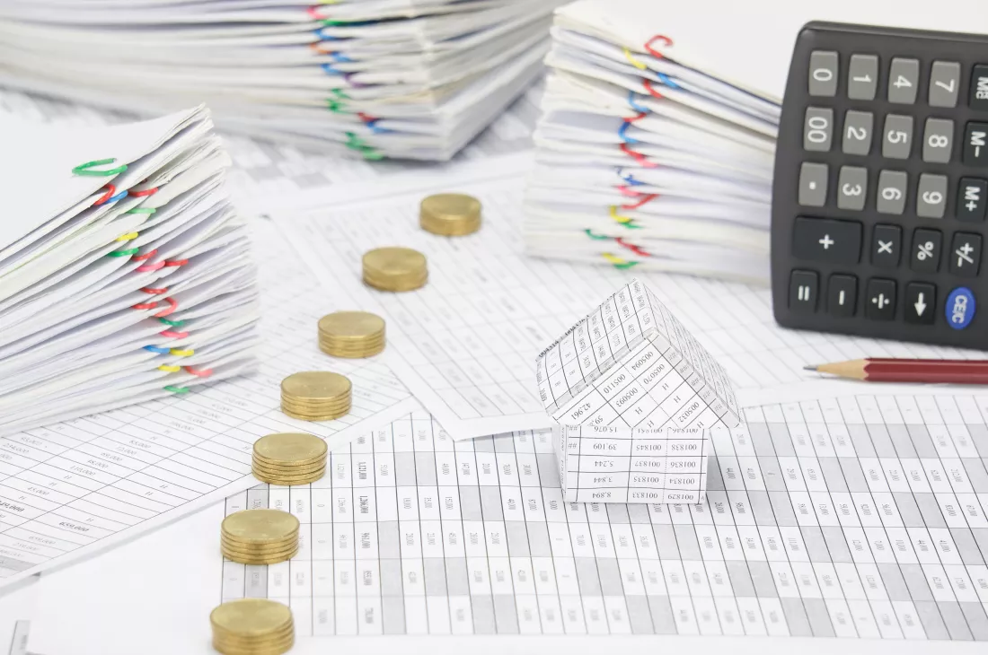 high-angle-view-coins-with-model-house-calculator-financial-documents-2