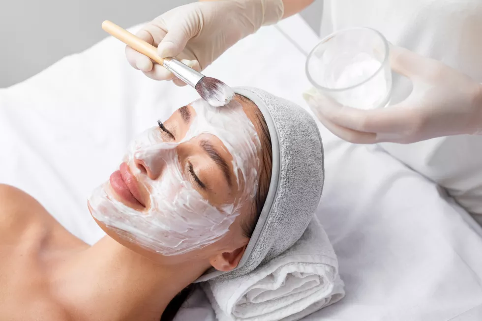 beautician-applying-white-clay-mask-face-beautiful-young-woman-beauty-salon-spa-treatments