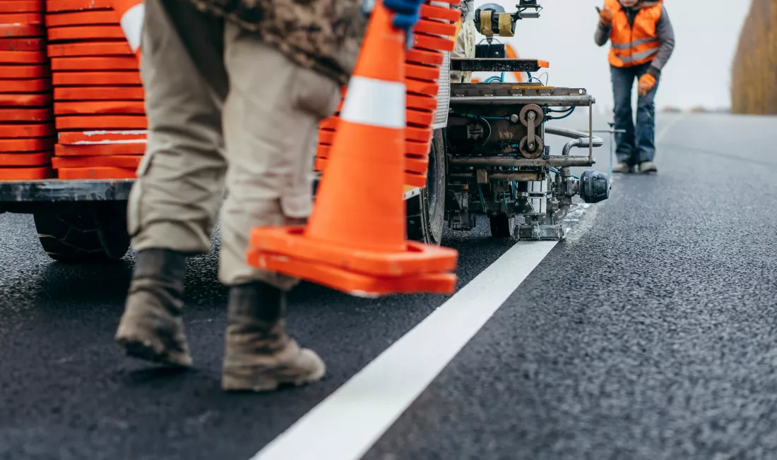workers-applying-new-road-markings-outside-city