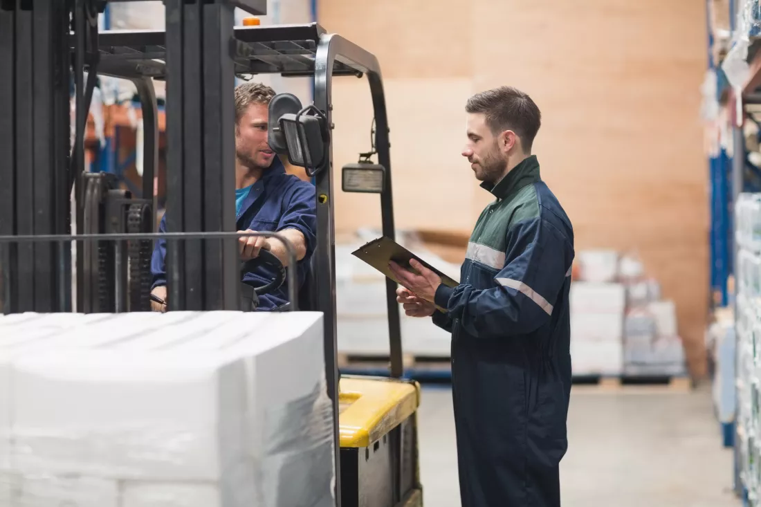 warehouse-worker-talking-with-forklift-driver