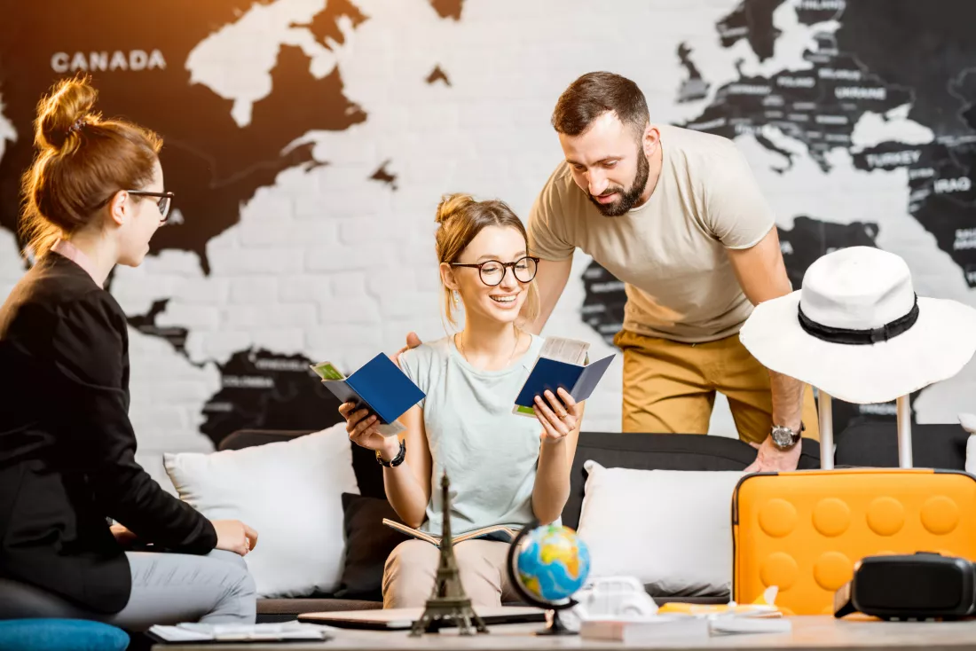 young-lovely-couple-sitting-with-manager-travel-agency-office-prepairing-summer-vacation