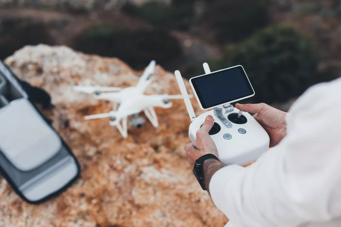 stock-aerial-video-creator-photographer-prepares-drone-flight