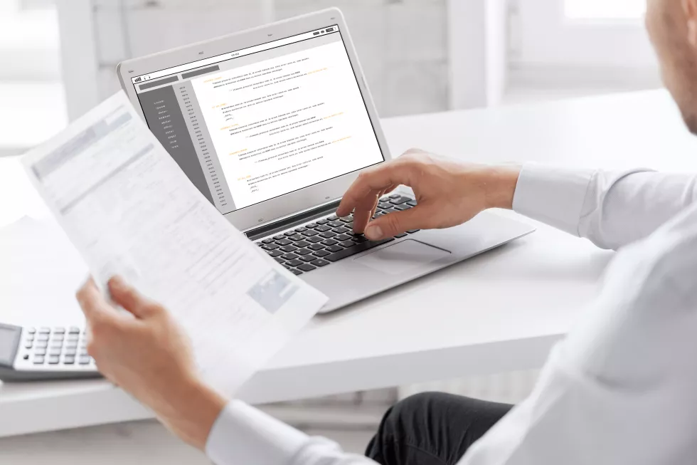 business-technology-programming-people-concept-close-up-businessman-with-coding-laptop-computer-screen-working-office