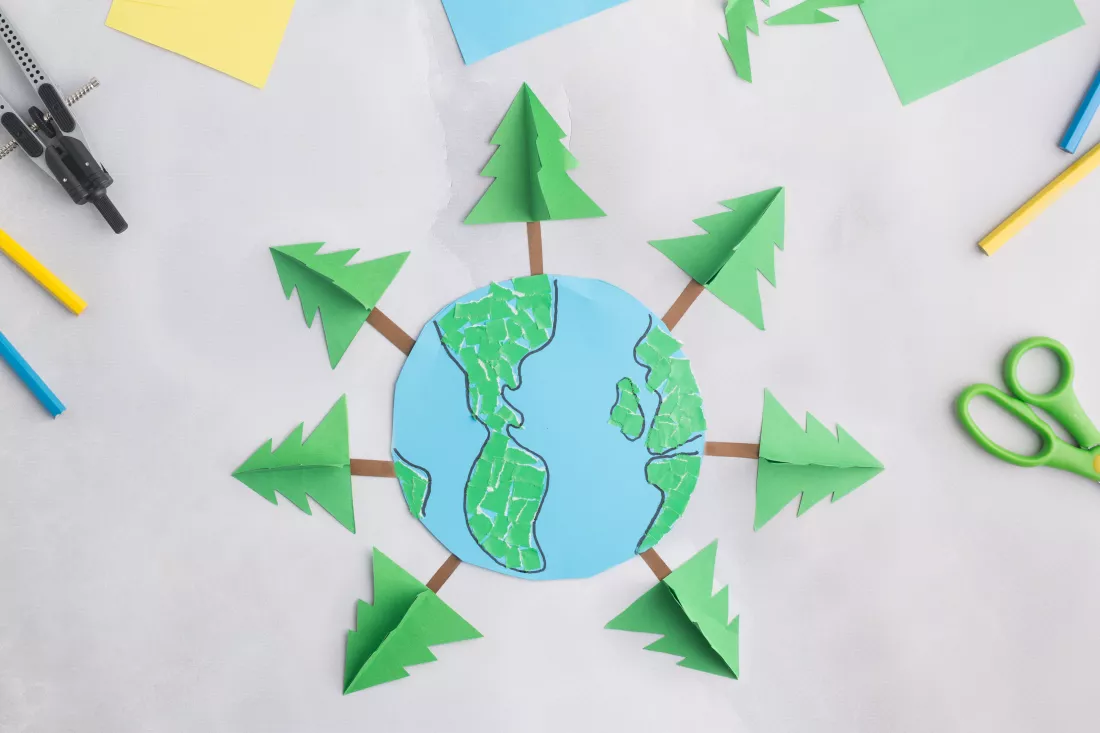 earth-cut-from-paper-around-trees-earth-day-concept-kids-paper-craft-high-quality-photo