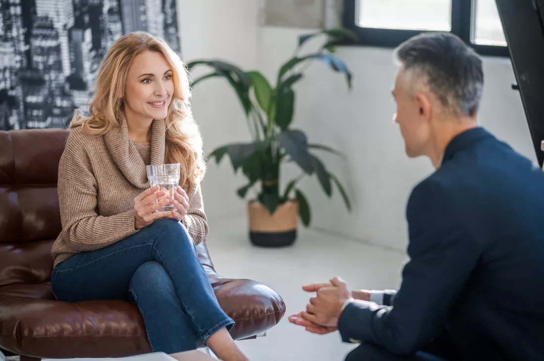 blonde-woman-talking-man-suit-looking-involved