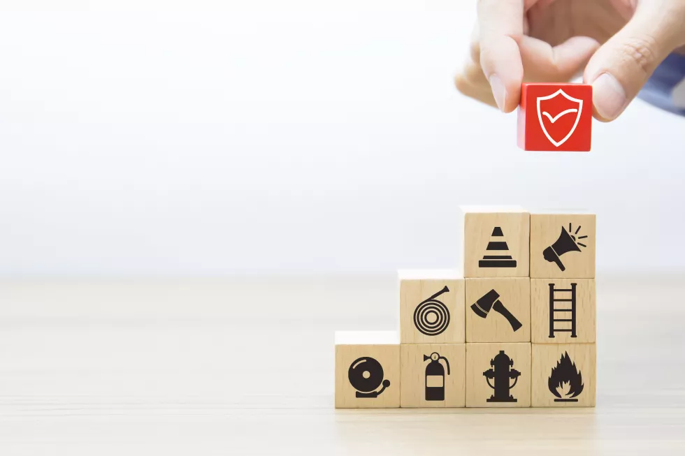 closeup-hand-chooses-protect-symbol-cube-wooden-toy-blocks