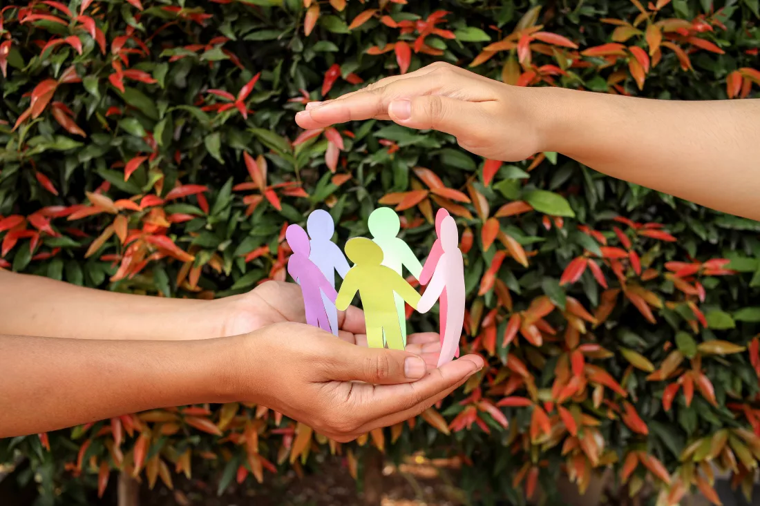 arrangement-paper-human-figures-making-circle-protective-hands-gesture