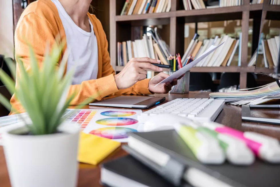 midsection-woman-working-with-book-table