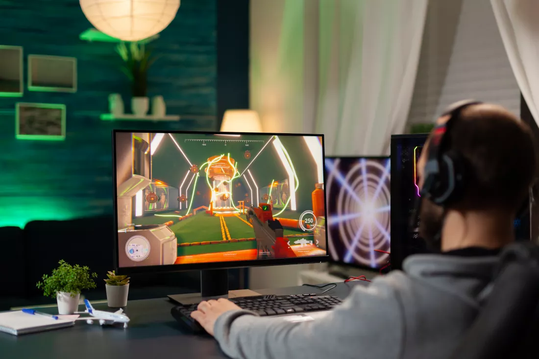 back-view-shot-focused-pro-gamer-streaming-videogames-professional-computer-using-headphones-online-streamer-cyber-performing-gaming-tournament-using-technology-network-wireless
