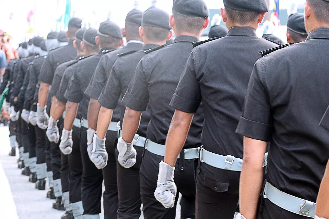 rear-view-men-uniform-standing-road