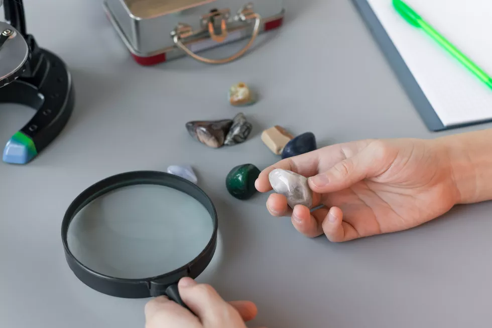 schoolboy-studying-semiprecious-stones-gray-desk-home-education-scientists-concept