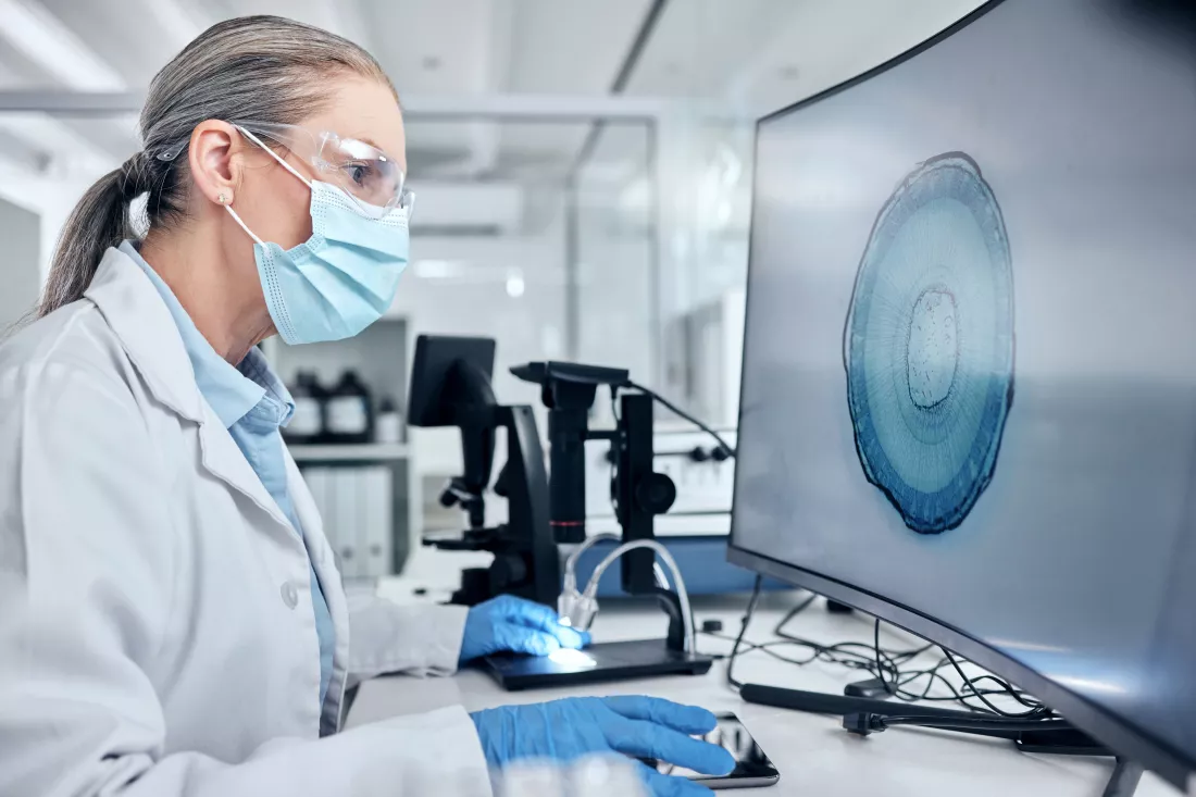 scientist-with-computer-screen-digital-microscope-ppe-analysis-bacteria-virus-test-vaccine-research-innovation-technology-medical-virus-expert-woman-with-pc-monitor-laboratory