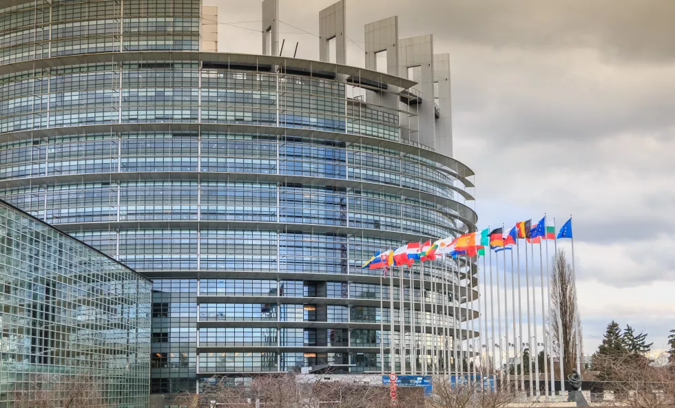 low-angle-view-modern-building-against-cloudy-sky