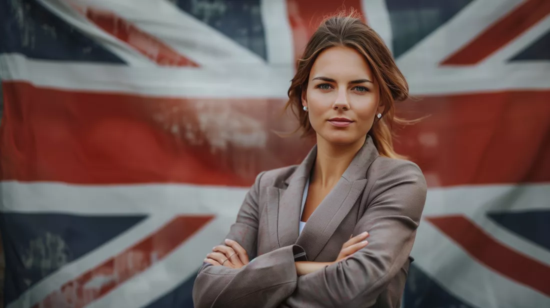 confident-young-woman-business-suit-poses-against-british-flag-backdrop