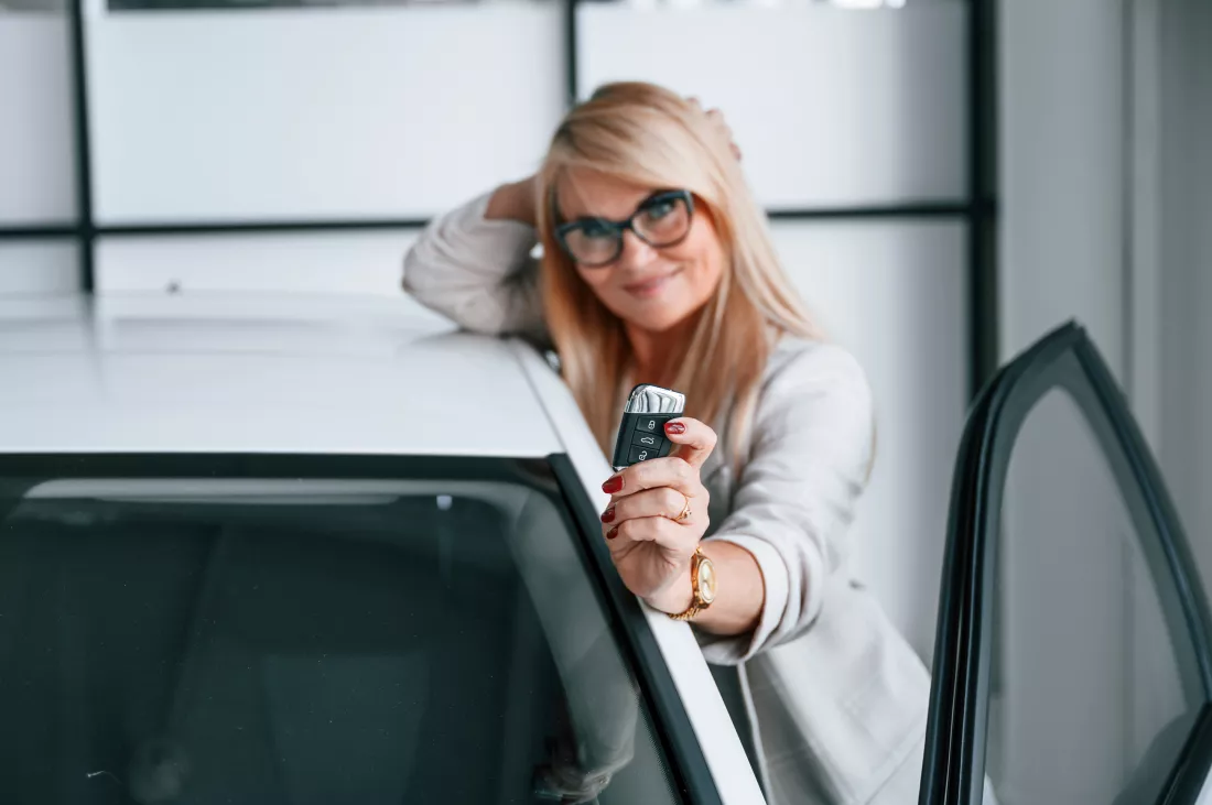 new-automobile-owner-woman-white-formal-clothes-is-car-dealership
