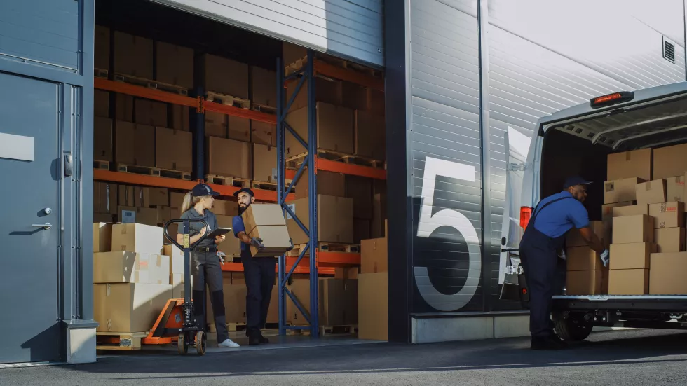 outside-logistics-distributions-warehouse-with-manager-using-tablet-computer-diverse-workers-loading-delivery-truck-with-cardboard-boxes-online-orders-purchases-ecommerce-goods