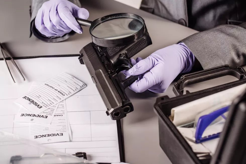 detective-through-magnifying-glass-looking-evidence