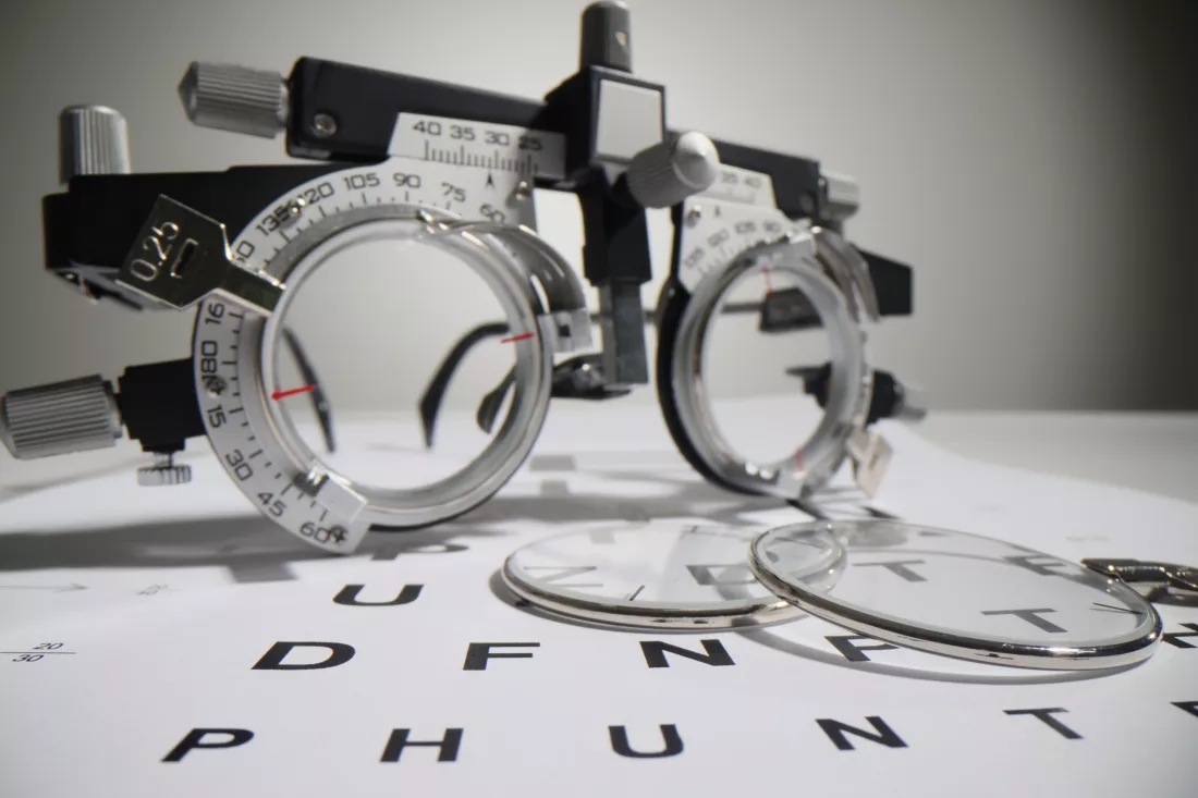 optometric-glasses-lie-snellen-chart-paper-with-letters