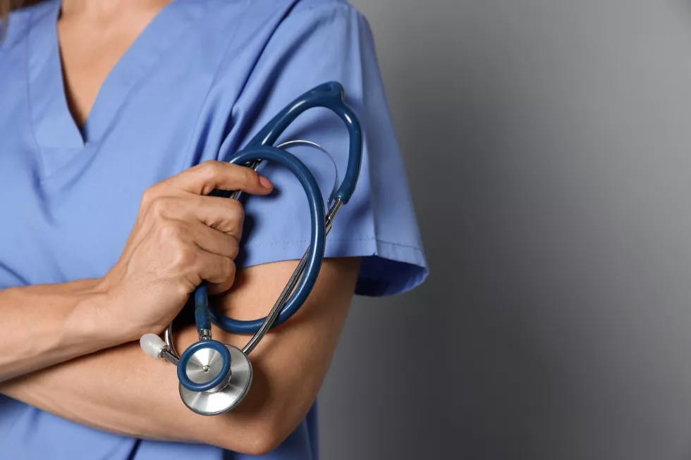 doctor-with-stethoscope-gray-background-closeup-space-text