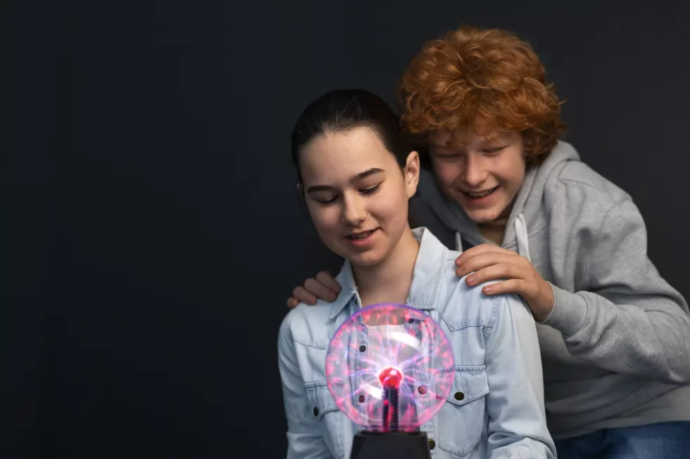 medium-shot-kids-interacting-with-plasma-ball