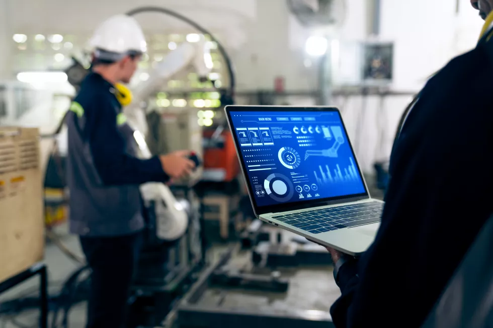factory-workers-working-with-adept-robotic-arm-workshop(2)