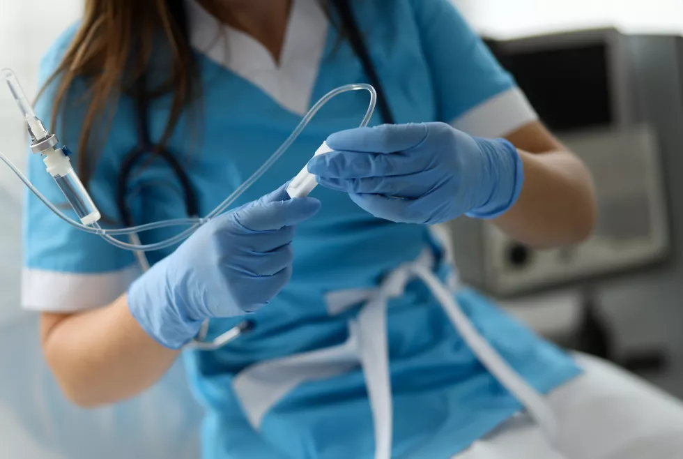 female-nurse-hand-blue-protective-gloves-hold-dropper