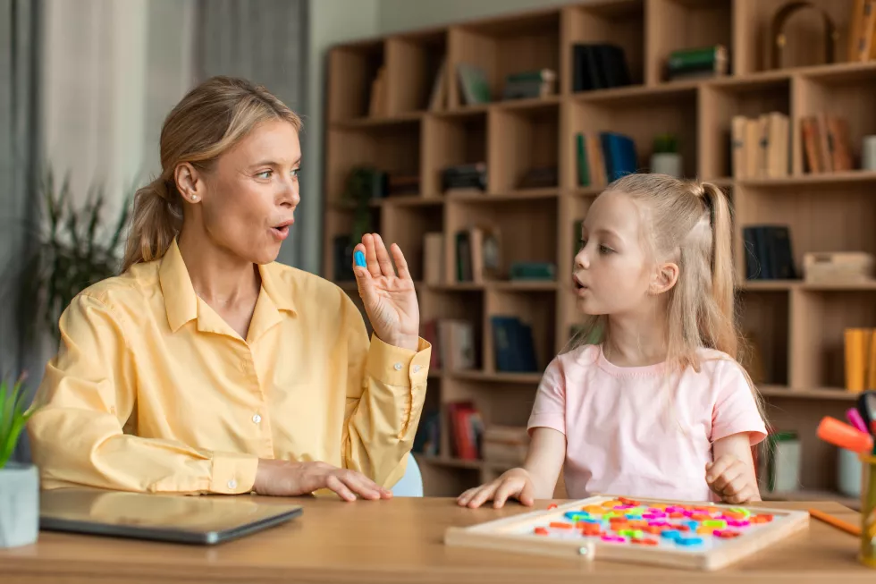 caring-mother-teaching-small-preschool-child-daughter-pronouncing-words-letters-correctly