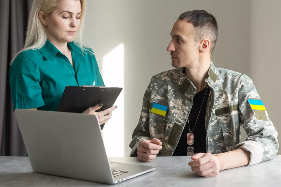 portrait-man-using-laptop-while-sitting-office