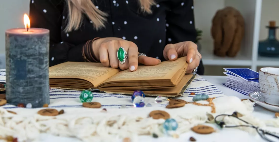 woman-fortune-teller-reads-book-spells-selective-focus