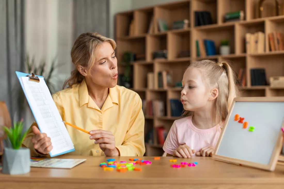 speech-training-kids-female-specialist-training-with-smart-little-girl-teaching-her-right-articulation-exercises
