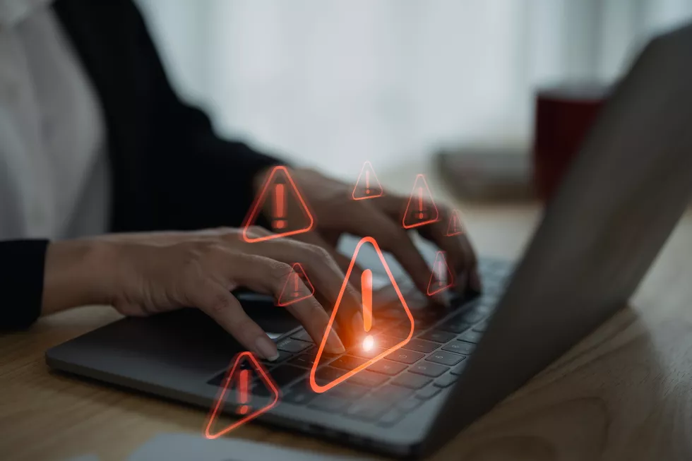 businesswoman-using-laptop-showing-virtual-screen-icon-caution-warning-triangle-exclamation-sign-icon-warning-dangerous-problems-server-error-virus-internet-network-security-concept