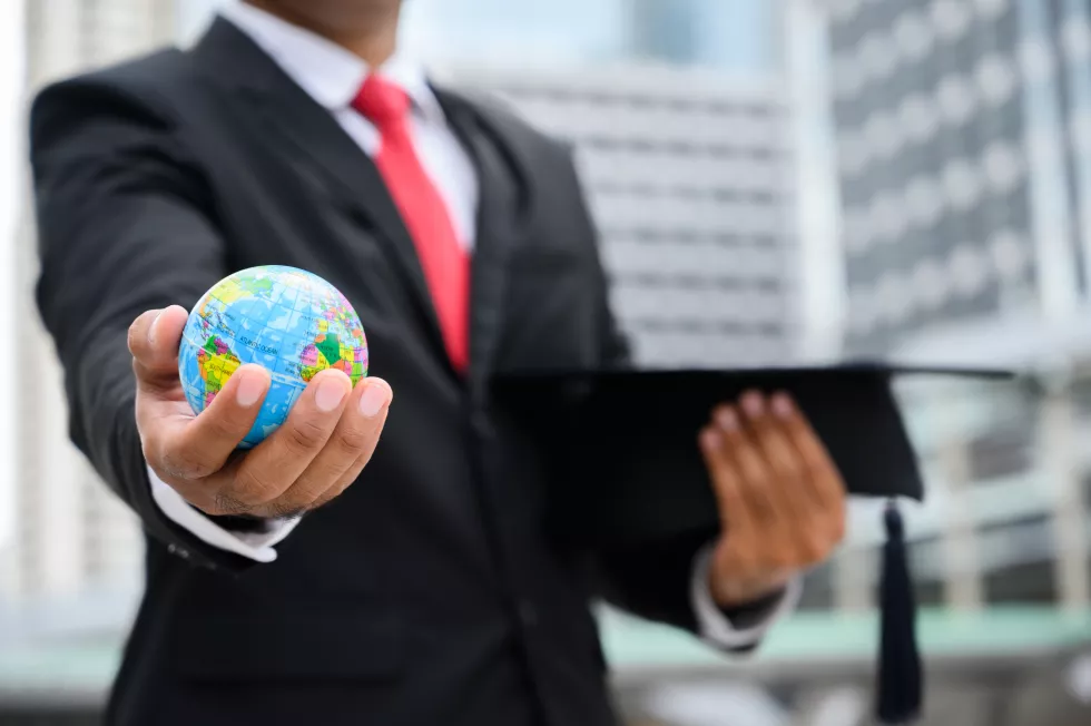 midsection-businessman-holding-globe