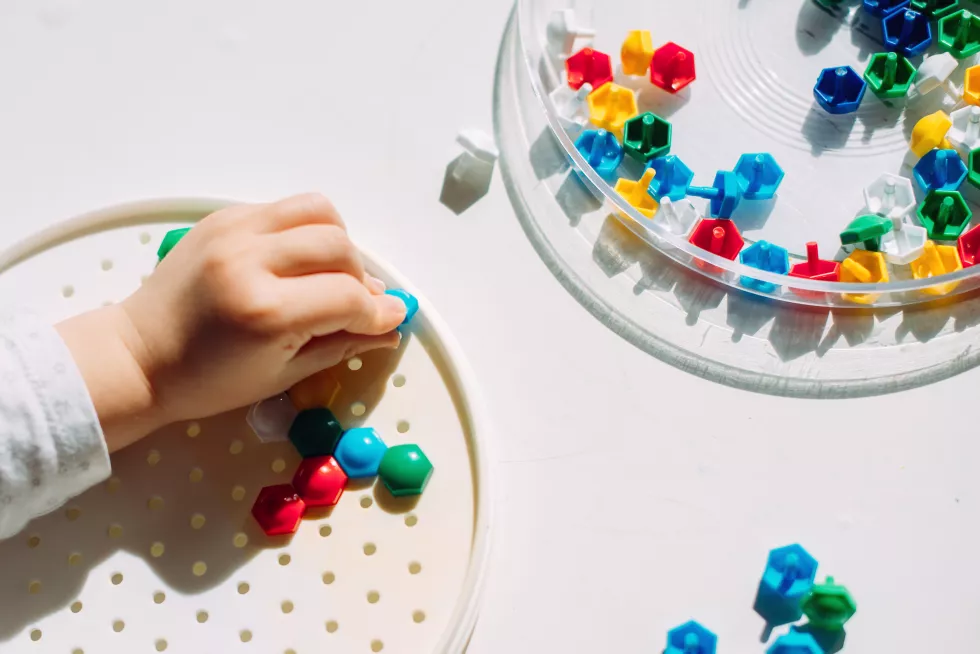 toddler-creates-multi-colored-mosaic-figure