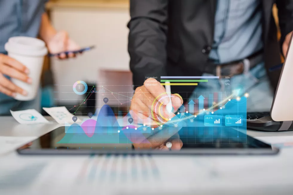 businessman-analyzing-company-financial-report-with-augmented-reality-graphic