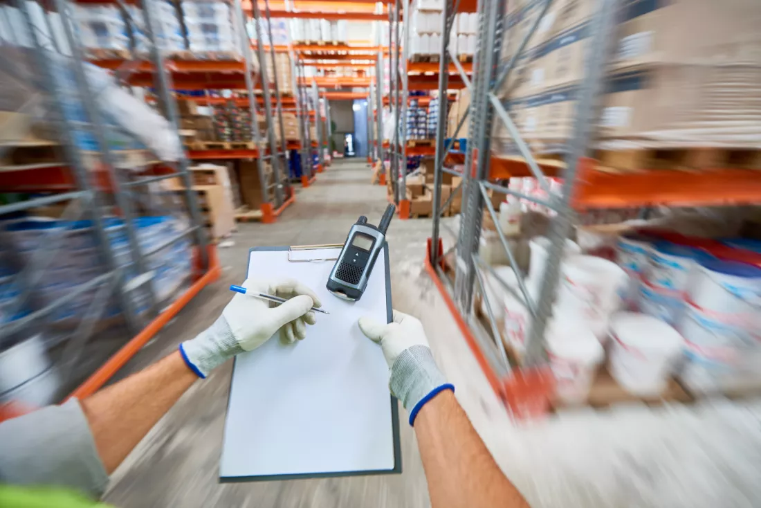 worker-making-notes-warehouse