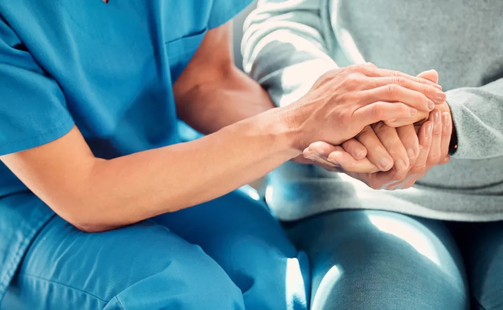 holding-hands-support-caregiver-with-senior-person-care-trust-nursing-home-people-retirement-nurse-help-elderly-woman-patient-with-professional-medical-advice