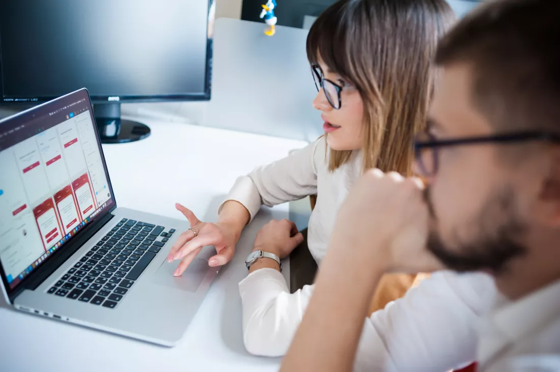 young-coworkers-using-laptop-office