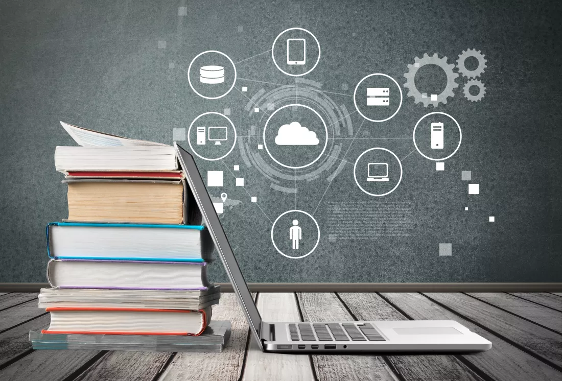 stack-books-with-laptop-wooden-table