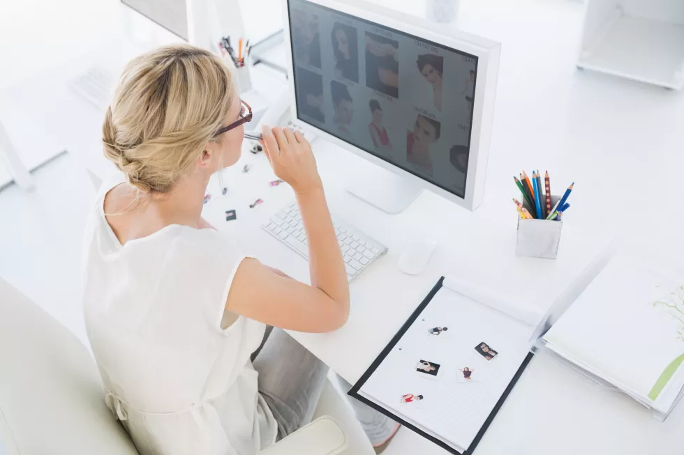 female-photo-editor-working-computer