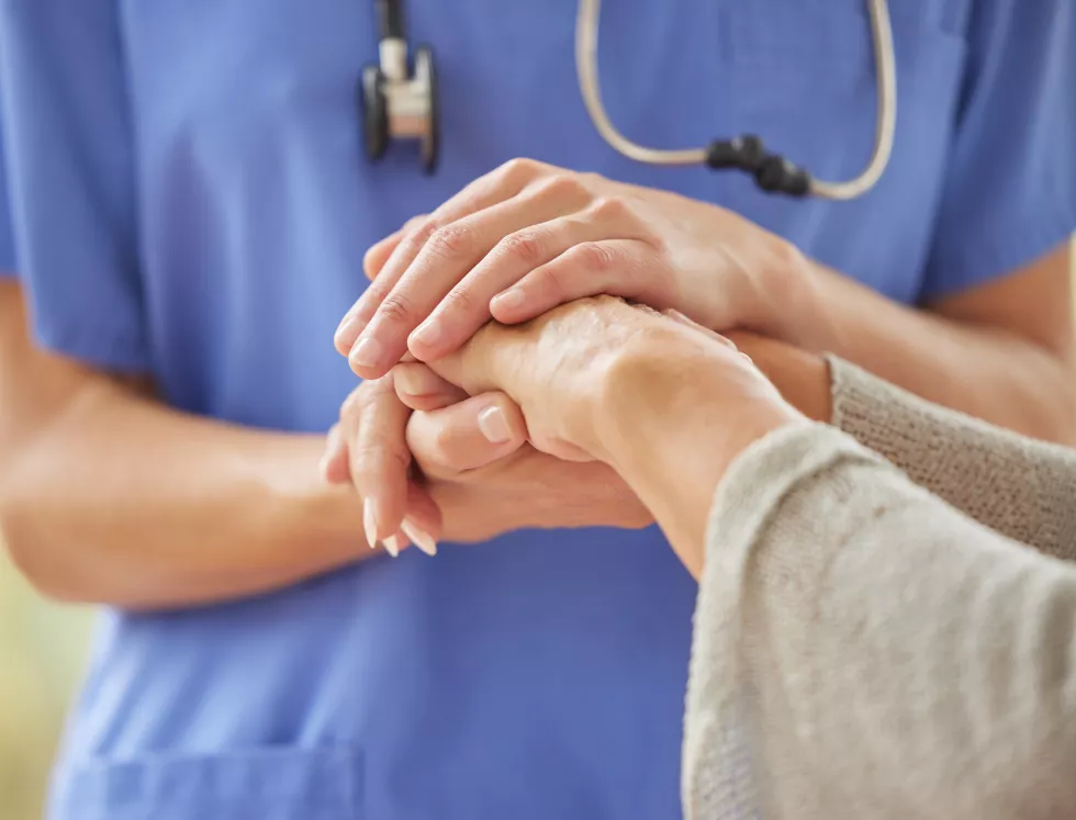 closeup-caring-nurse-comforting-senior-patient-old-age-home-zoomed-unknown-elderly-woman-being-supported-touching-holding-medical-aids-hand-elderly-woman-bonding-with-her-caregiver