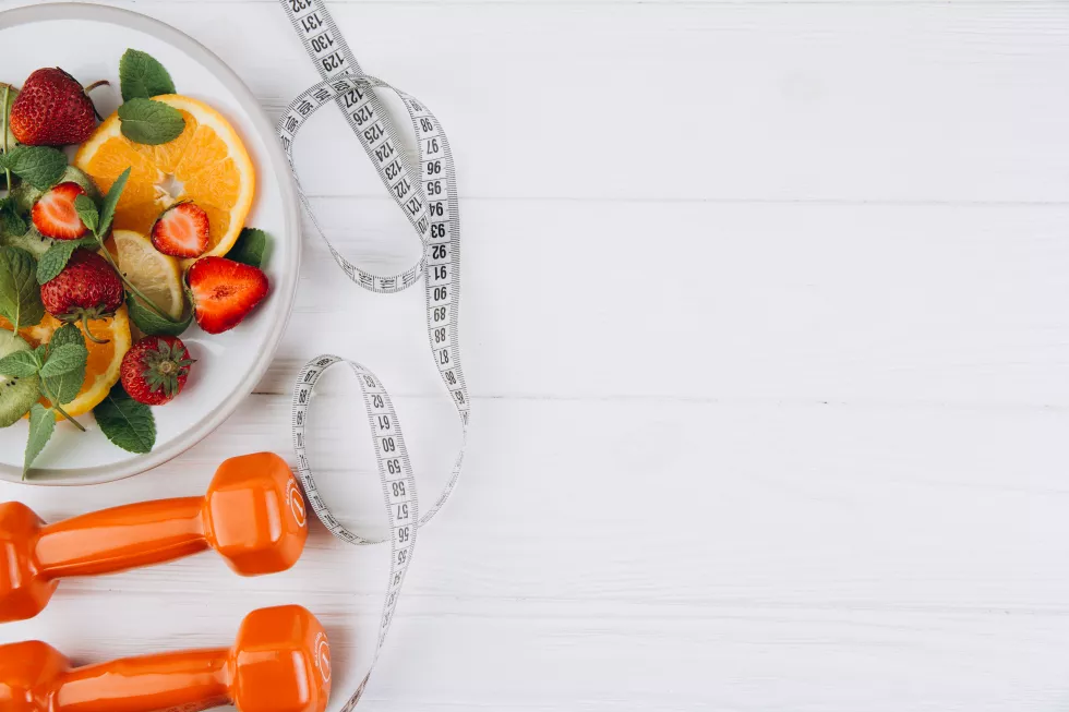 diet-plan-menu-program-tape-measure-water-dumbbells-diet-food-fresh-fruits-white