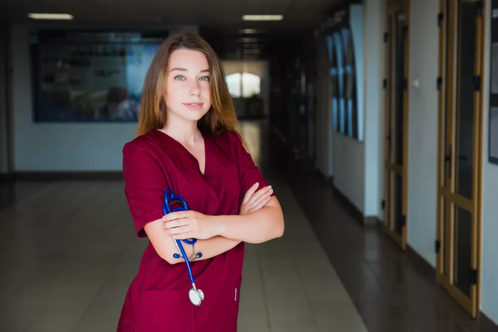 medical-student-smiling-camera-university-burgundy-surgical-suit-professional-girl-surgeon-doctor