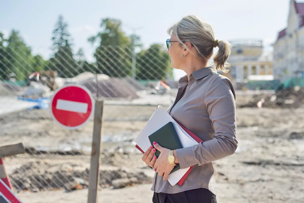 outdoor-portrait-business-mature-woman-paving-stone-laying