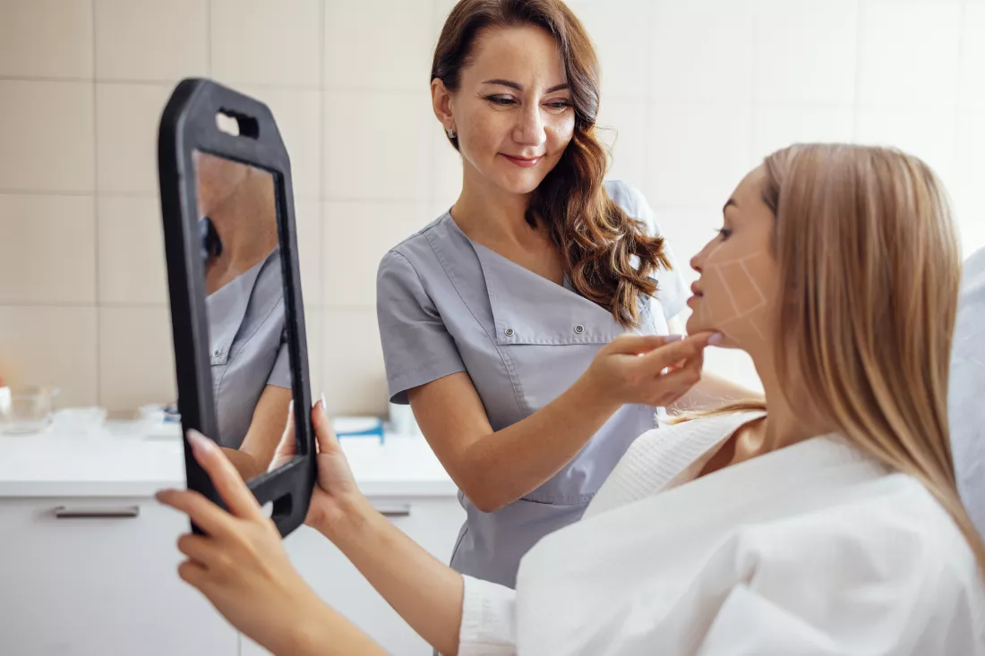portrait-smiling-friends-using-mobile-phone-while-sitting-bed