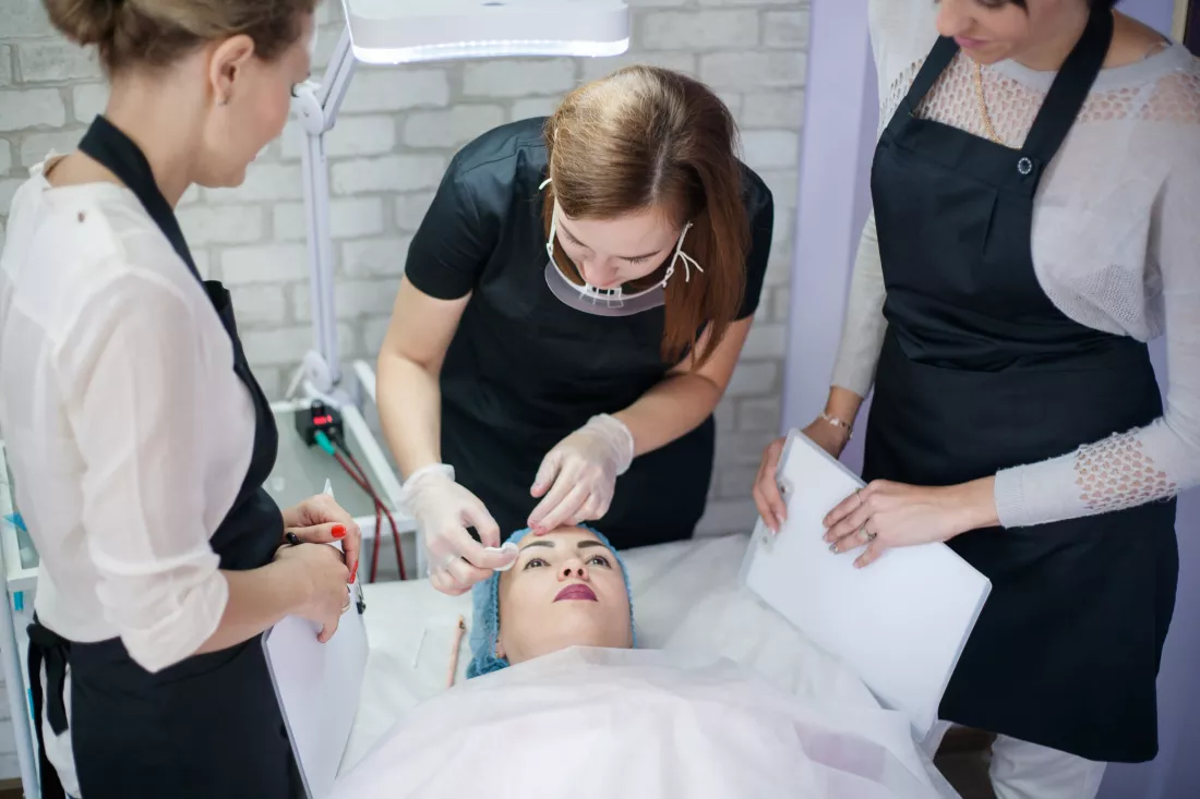 professional-skin-care-therapy-female-beauticians-working-with-client-modern-clinic
