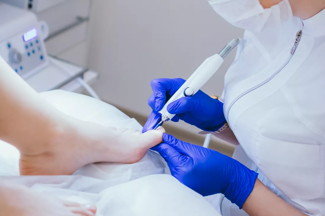 professional-hardware-pedicure-using-electric-device-client-medical-pedicure-procedure