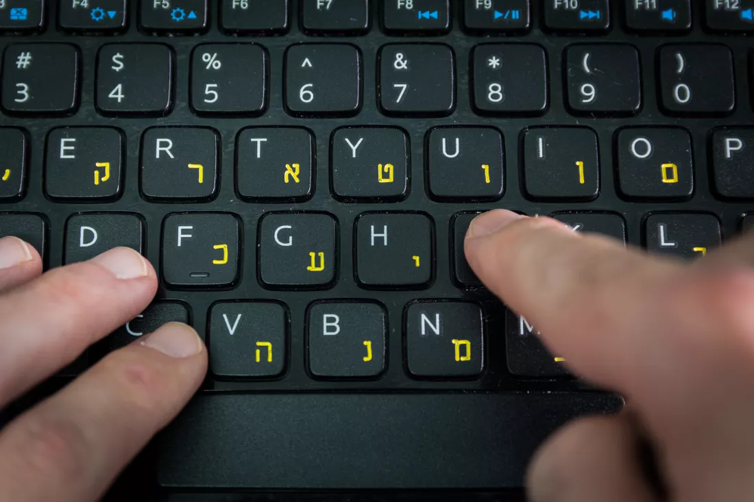 cropped-hand-using-laptop