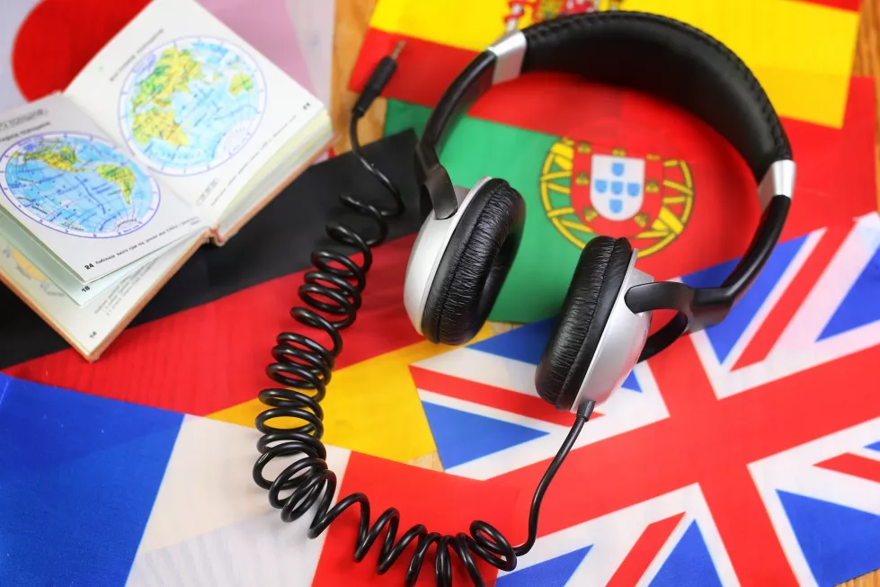 language-course-headphone-flag-wooden-table