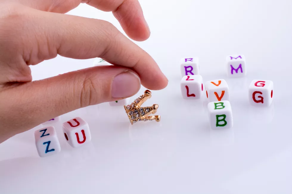 close-up-hand-woman-holding-crown-white-background